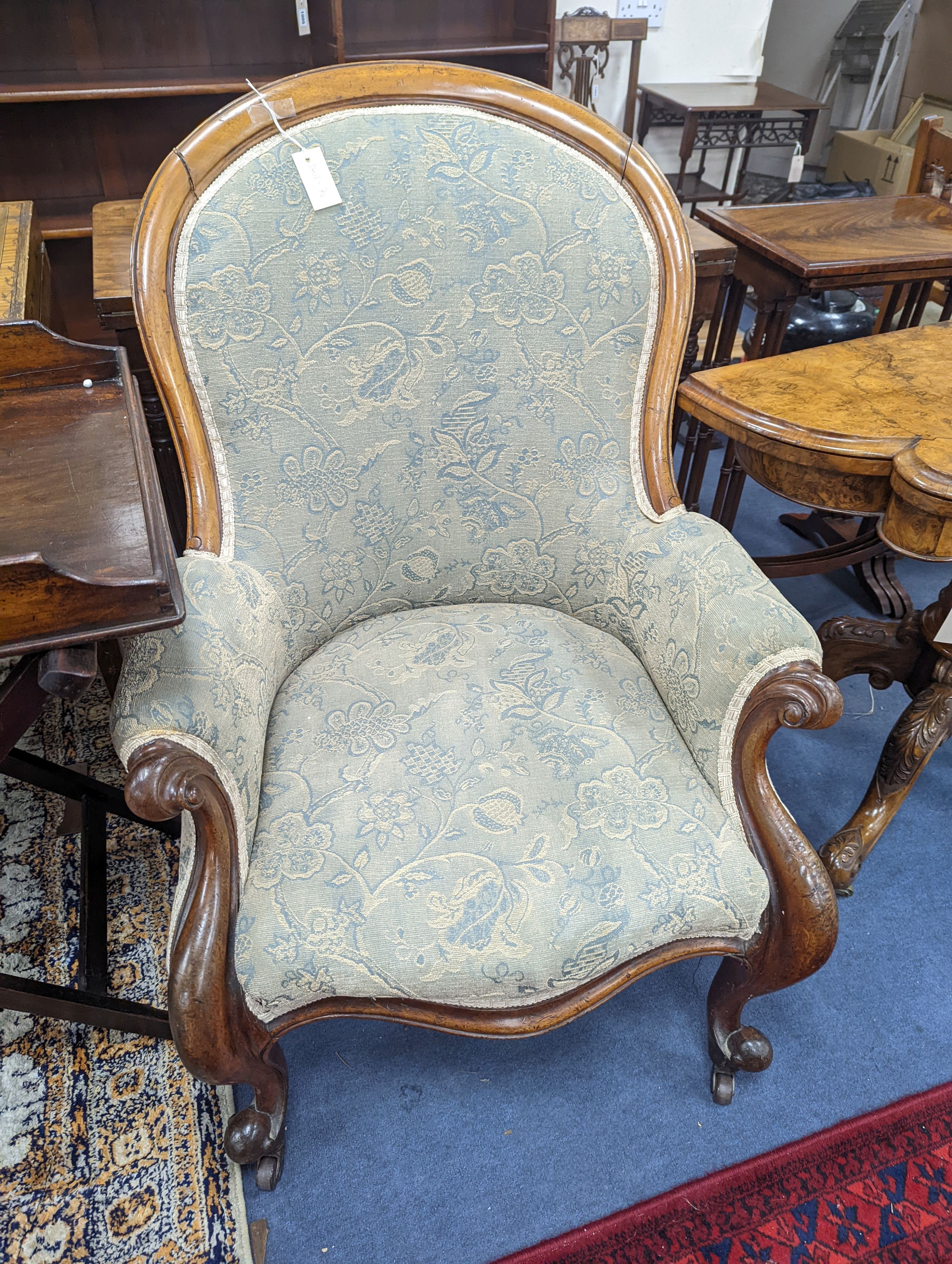 An upholstered Victorian armchair